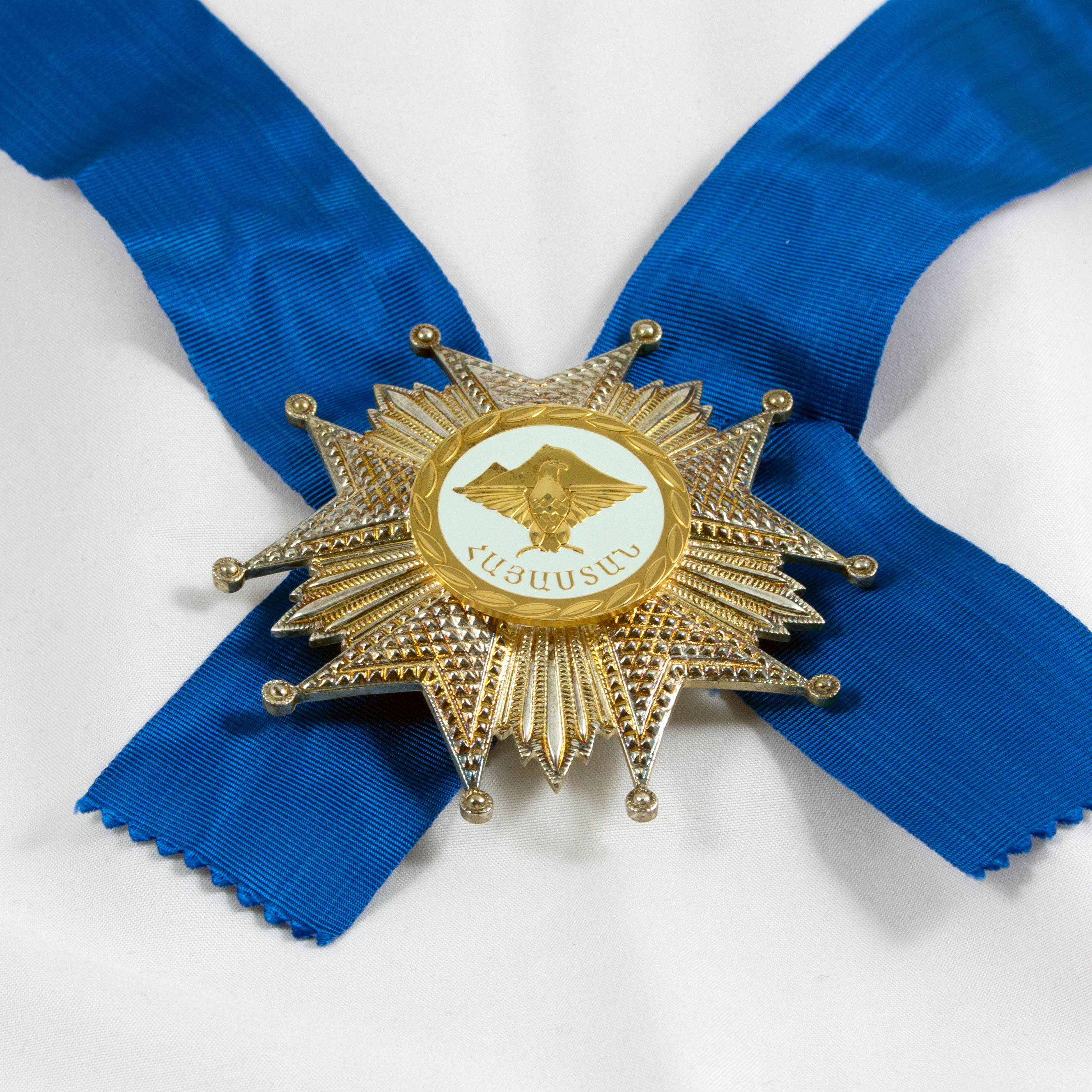 gold medal on blue ribbon