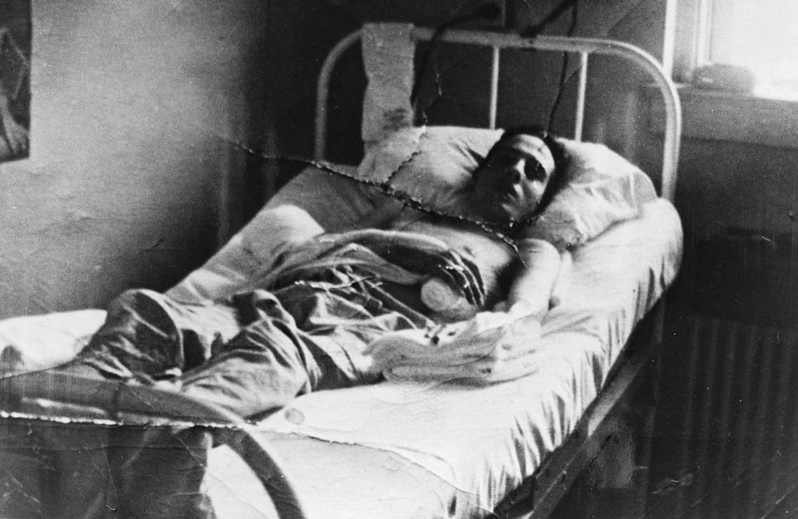 A person lying in a hospital bed